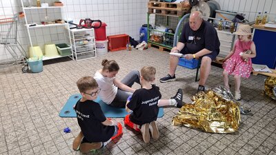 Bild vergr&ouml;&szlig;ern: Die Bambini-Gruppe im Fallbeispiel bei der Betreuung einer verletzten Person mit einer Knieverstauchung